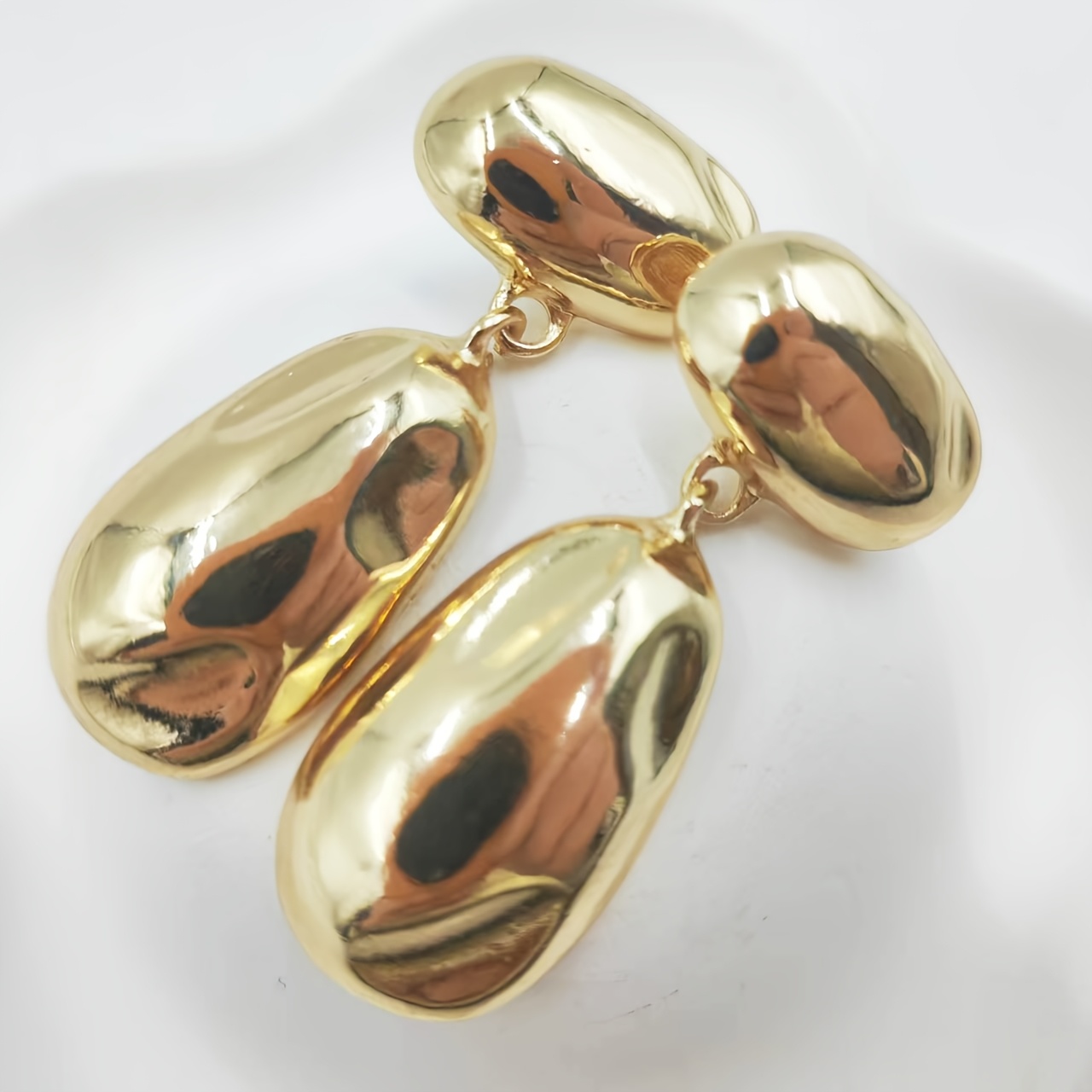 Metal Earrings with Golden Glossy Finish and Teardrop Pendant